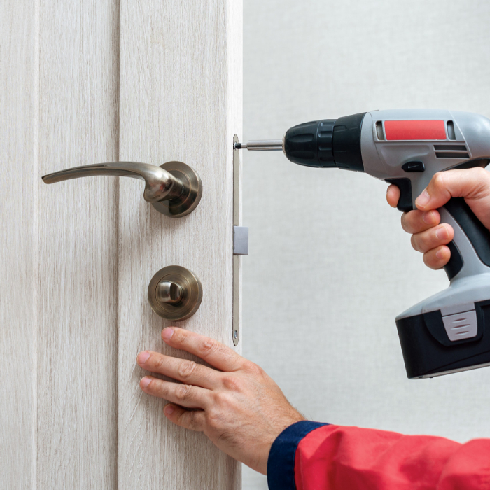Installation d’une serrure sur porte intérieure avec perceuse pour des travaux de serrurerie